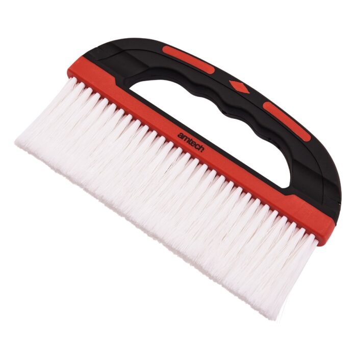 Wide wallpaper smoothing brush with a red and black handle and white bristles.